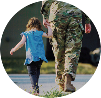 A child and a person wearing military uniform walking hand in hand