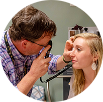 A doctor examines a patient's eyes